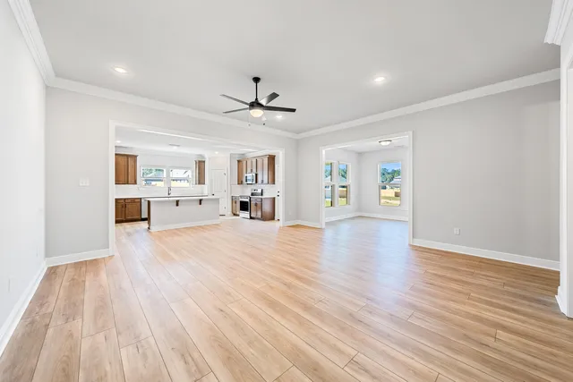 a view of a kitchen with furniture and wooden floor