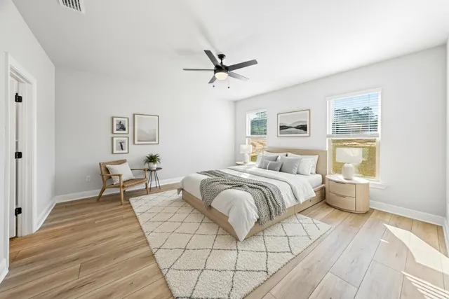 a spacious bedroom with a bed and window