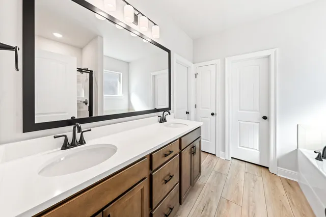 a bathroom with a double vanity sink and a mirror