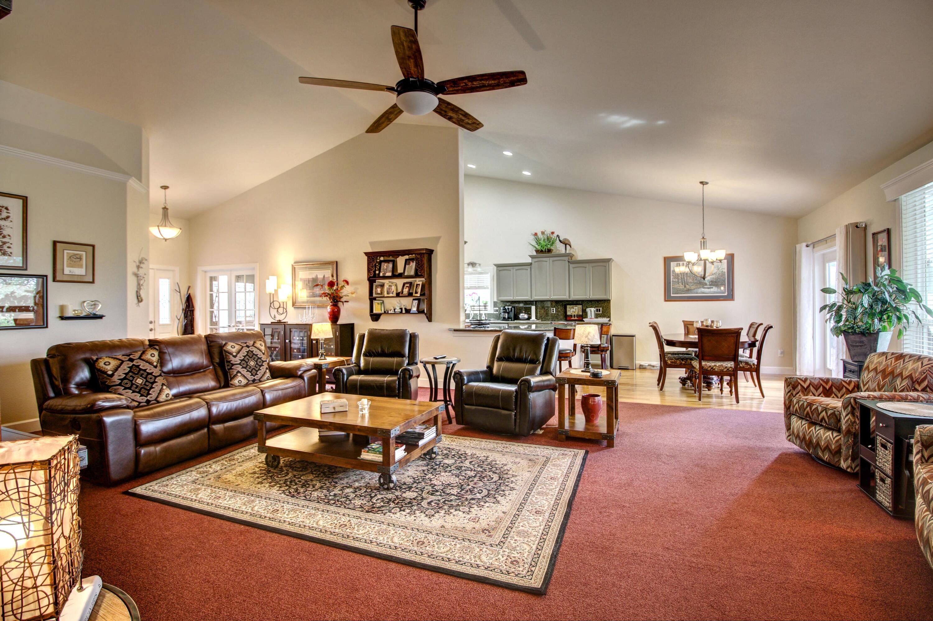 33 Broken Stone Way Eagle Point, OR 97524 - Photo 12 of 33 a living room with furniture and a dining table with wooden floor