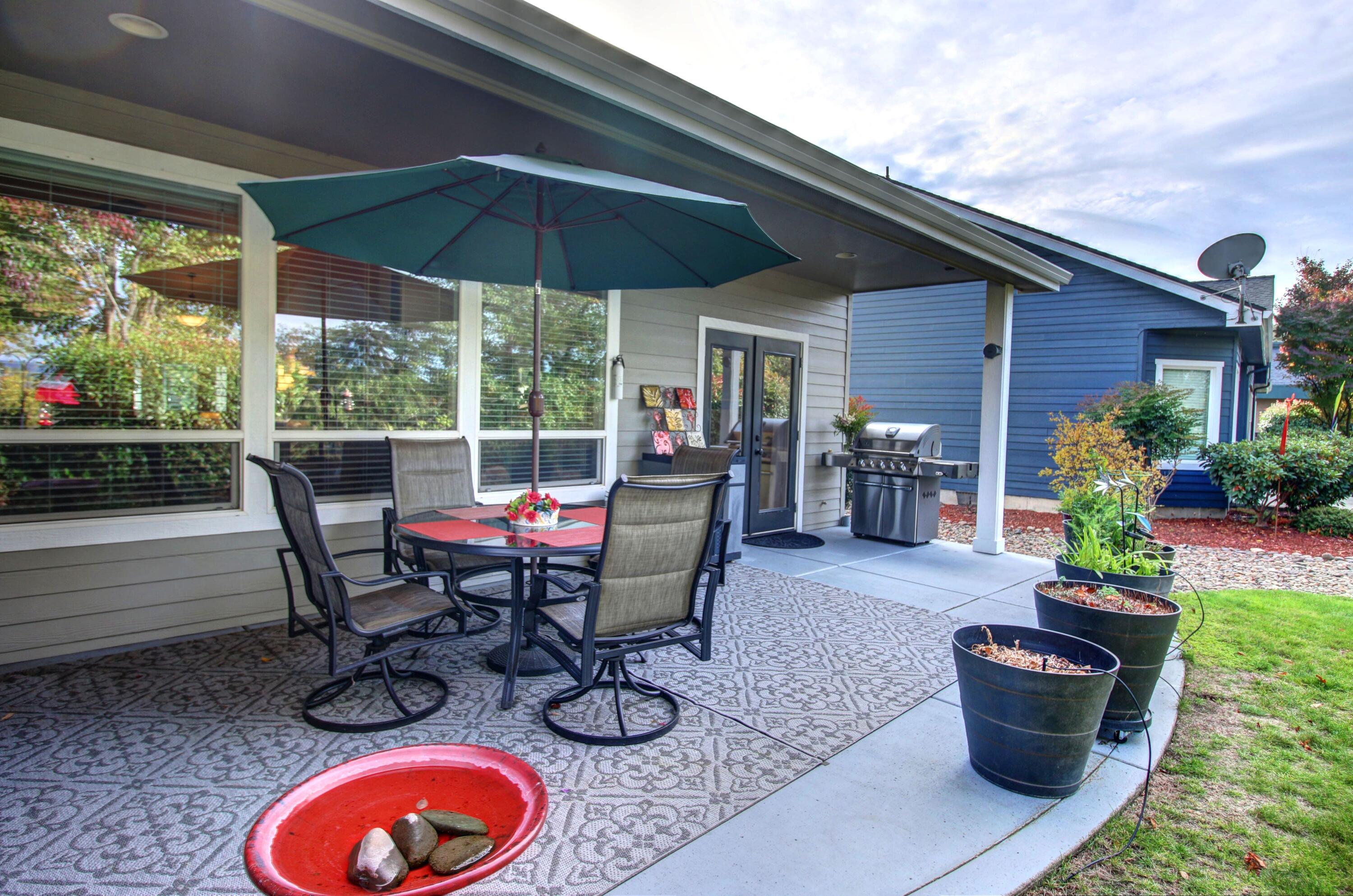 33 Broken Stone Way Eagle Point, OR 97524 - Photo 31 of 33 a view of a patio with chairs and potted plants