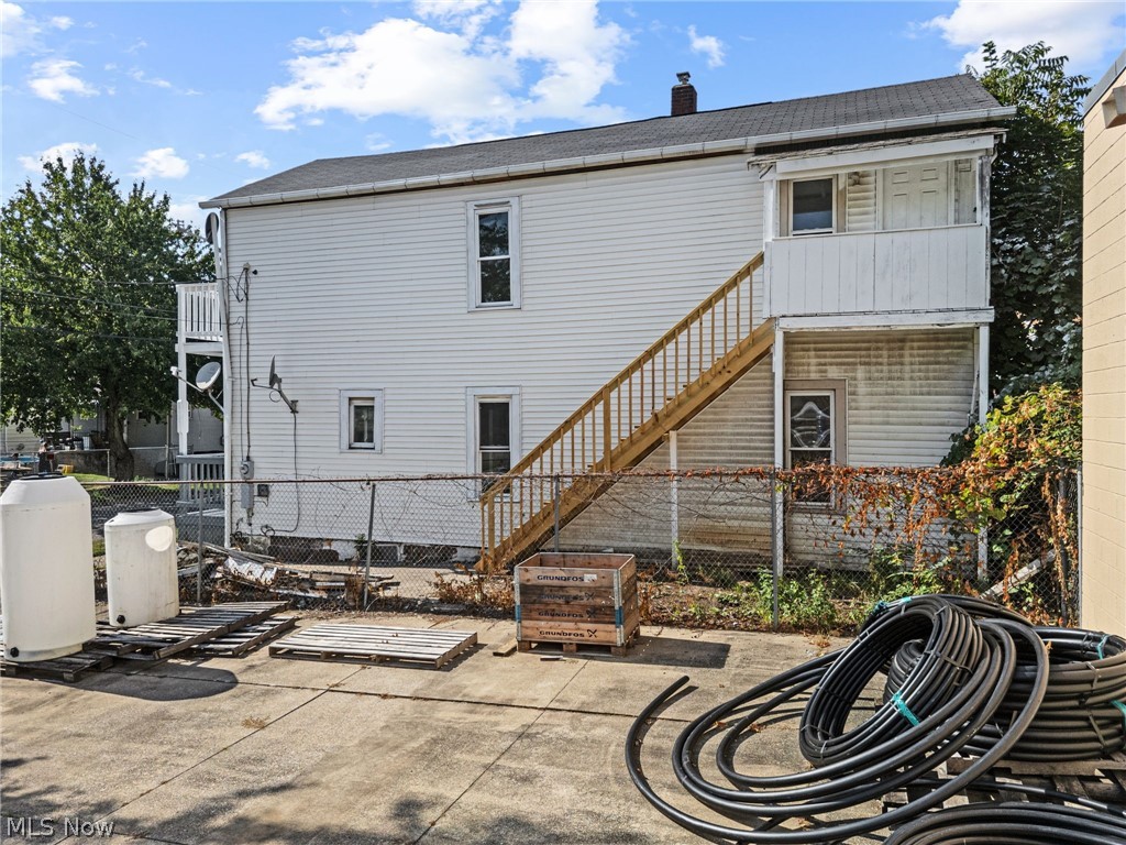 2387 29th Street Southwest Akron, OH 44314 - Photo 14 of 24 Rear view of house with a balcony, a chimney, and roof with shingles
