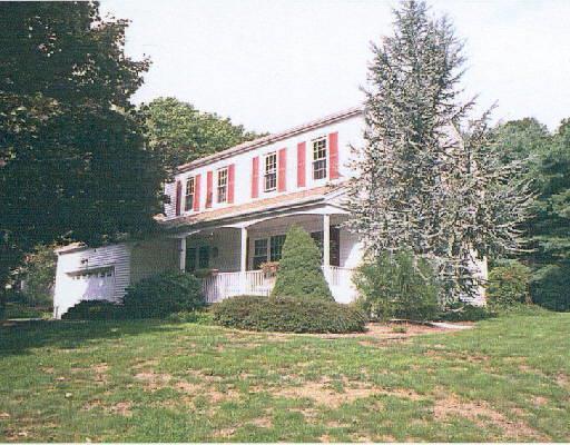 218 North Street Ridgefield, CT 06877 - Photo 1 of 1 a front view of a house with a garden and plants