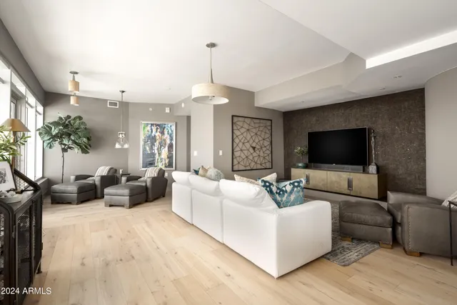 a bedroom with a bed a chair and next to a window