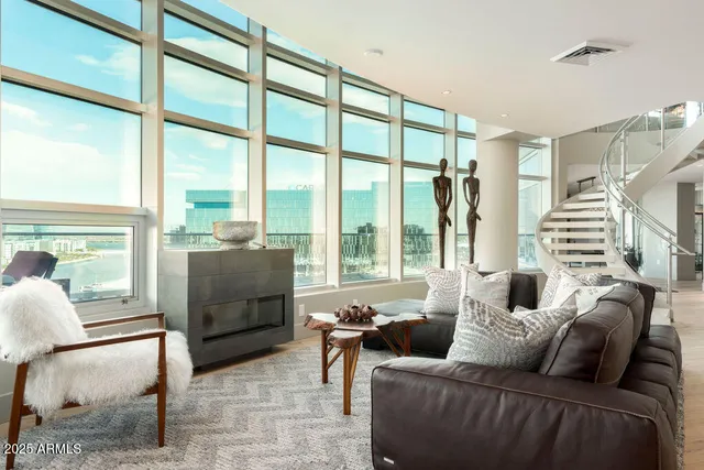 a living room with furniture and a potted plant