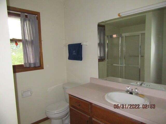Undisclosed Address Pleasant Prairie, WI 53158 - Photo 11 of 13 a bathroom with a granite countertop sink toilet and mirror
