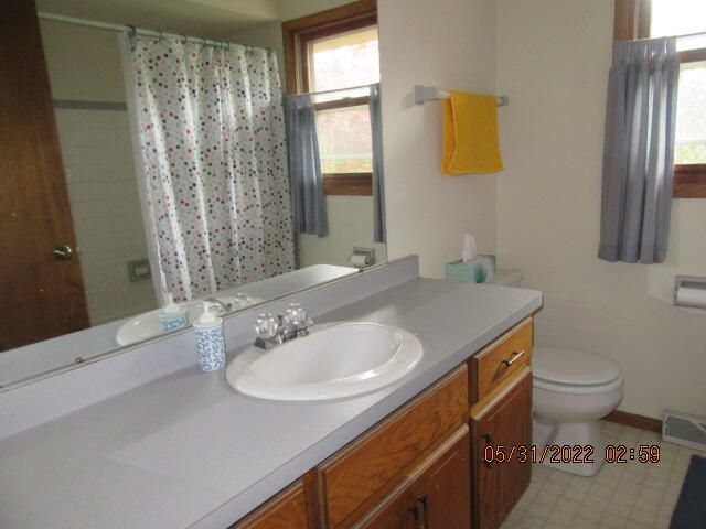 Undisclosed Address Pleasant Prairie, WI 53158 - Photo 12 of 13 a bathroom with a sink and a mirror