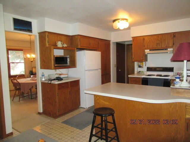 Undisclosed Address Pleasant Prairie, WI 53158 - Photo 5 of 13 a kitchen with stainless steel appliances granite countertop a refrigerator a stove and a sink