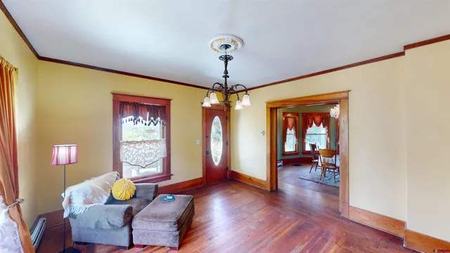 a living room with furniture and a chandelier