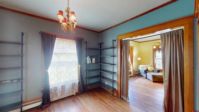 a view of an entryway with wooden floor and workspace