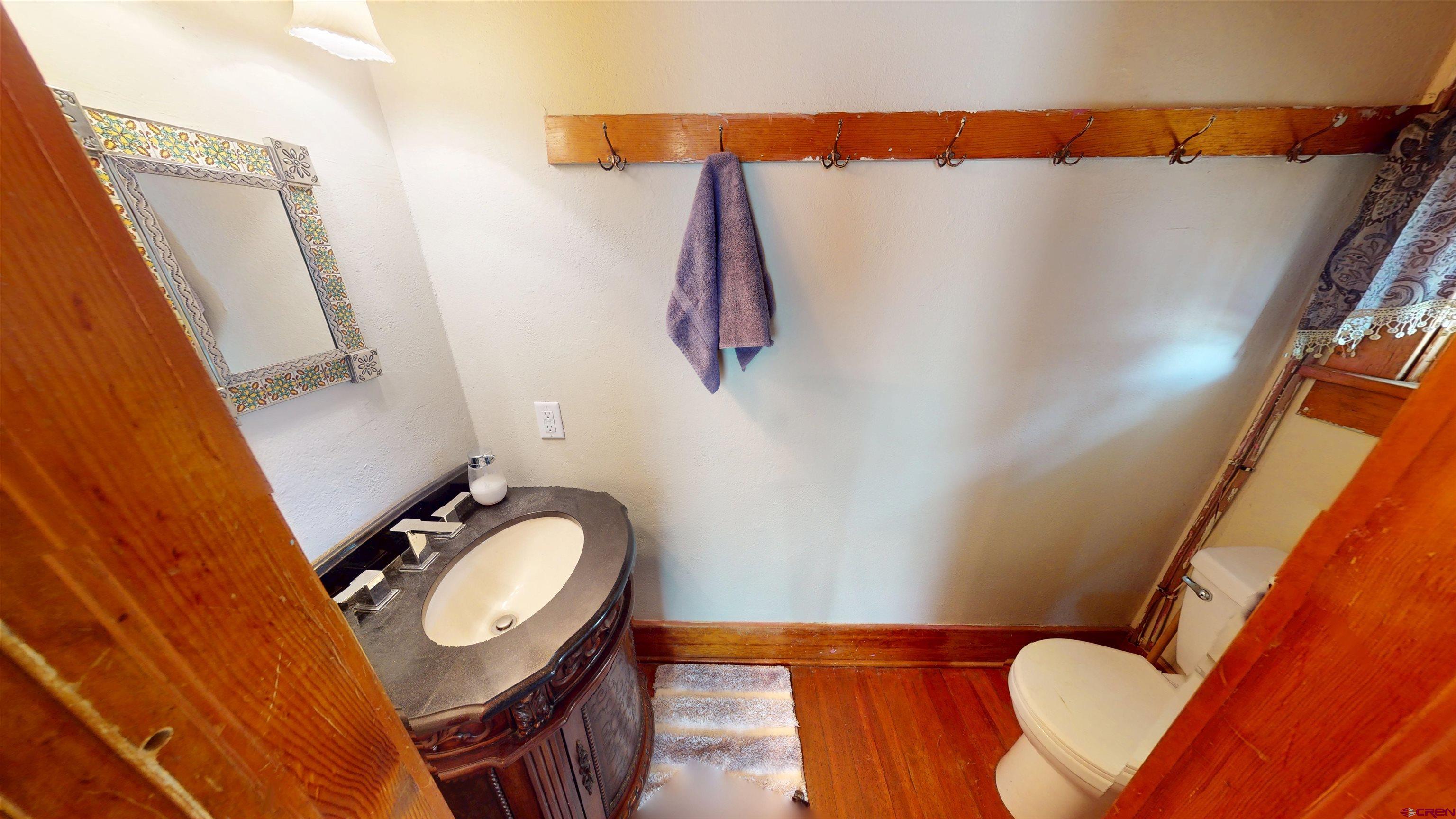 39778 Pitkin Road Paonia, CO 81428 - Photo 16 of 45 a bathroom with a sink mirror vanity and toilet