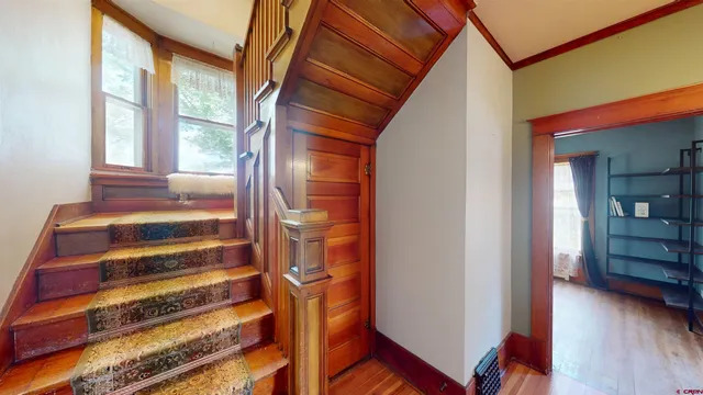a view of entryway with wooden floor and windows