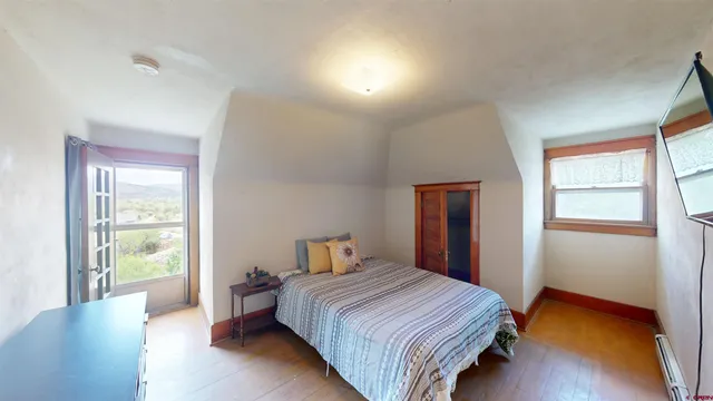 a bedroom with a bed and a window