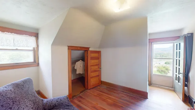 a view of room with window and wooden floor