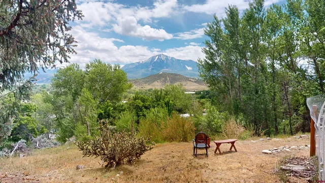 a backyard of a house with table and chairs