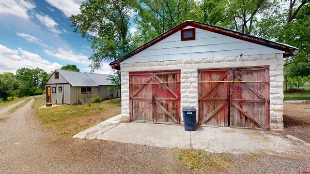 a view of a house with wooden fence next to a road