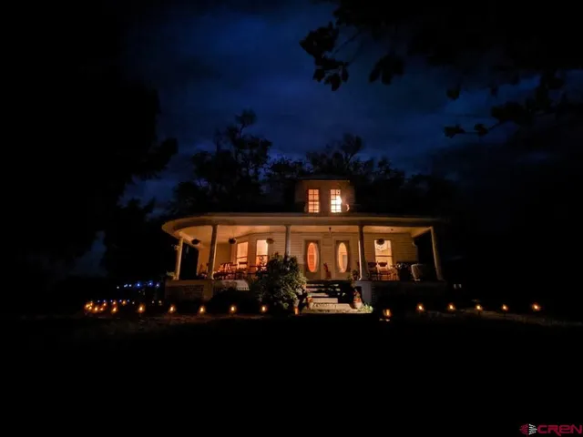 a front view of a house with a yard and mountain view
