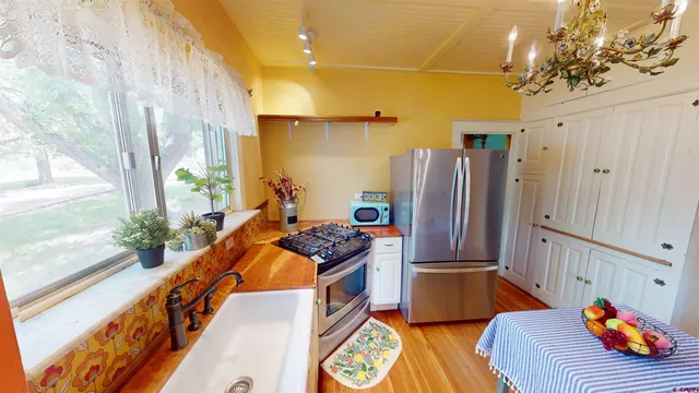 a kitchen with stainless steel appliances kitchen island granite countertop a refrigerator and a stove