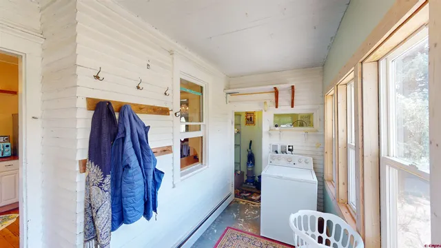 a very nice looking room with a big window and furniture