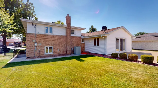 a front view of a house with a yard and balcony