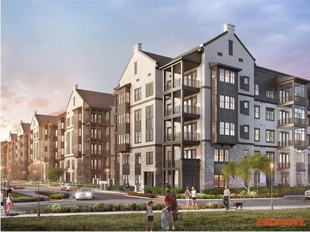 a front view of a building with lot of cars and trees