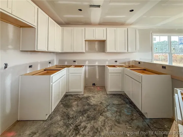 a kitchen with sink cabinets and window