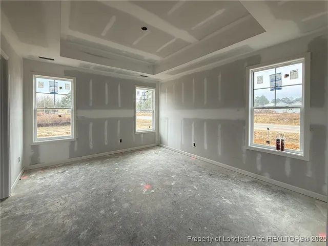 an empty room with windows and closet
