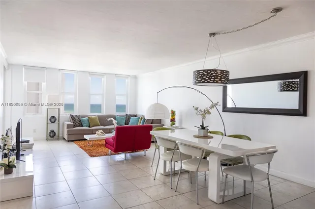 a living room with furniture a rug and a chandelier