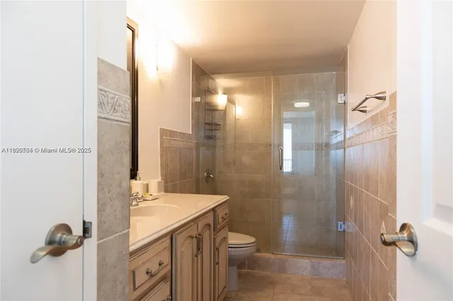 a bathroom with a shower and a toilet