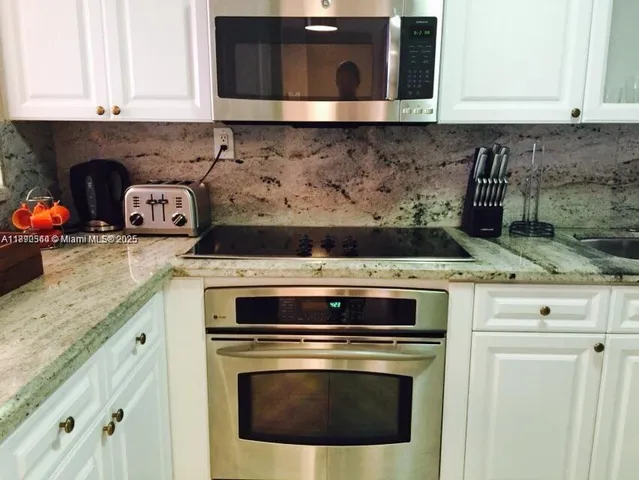 a stove top oven sitting inside of a kitchen