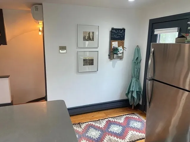 a view of room with window and refrigerator