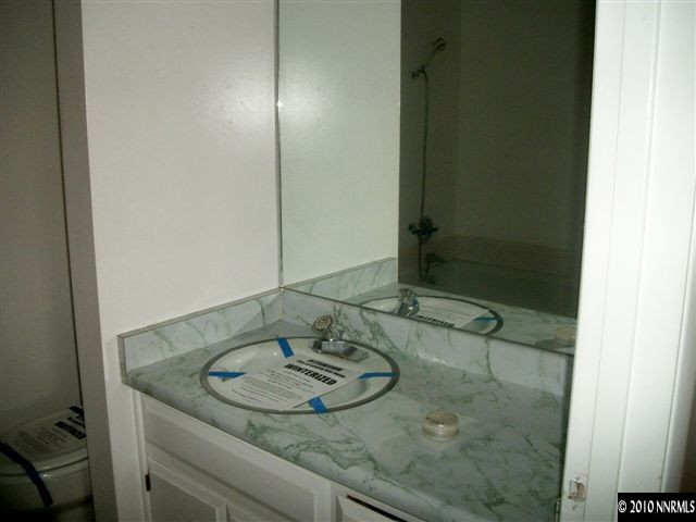 280 Wildrose Drive Reno, NV 89509 - Photo 9 of 9 a bathroom with a granite countertop sink and a mirror