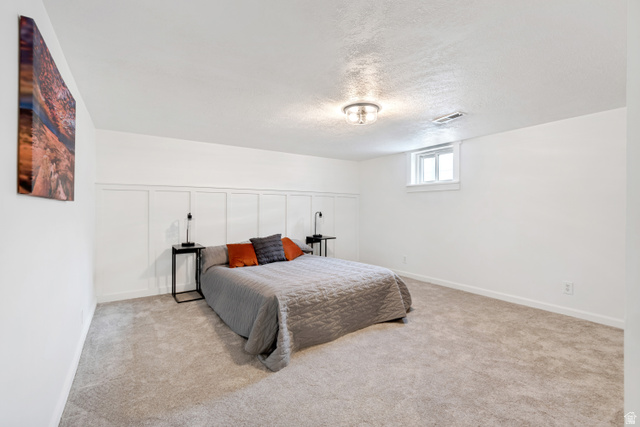 4883 South Center Street Murray, UT 84107 - Photo 24 of 32 Bedroom 3. Carpeted room featuring a wainscoting accent wall, a flush-mount ceiling light fixture, and a single window