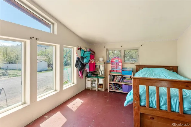 a living room with furniture a rug and a window