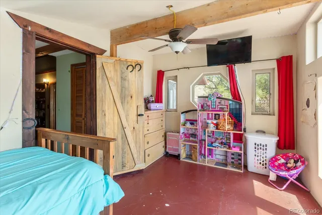 a bedroom with a bed and ceiling fan