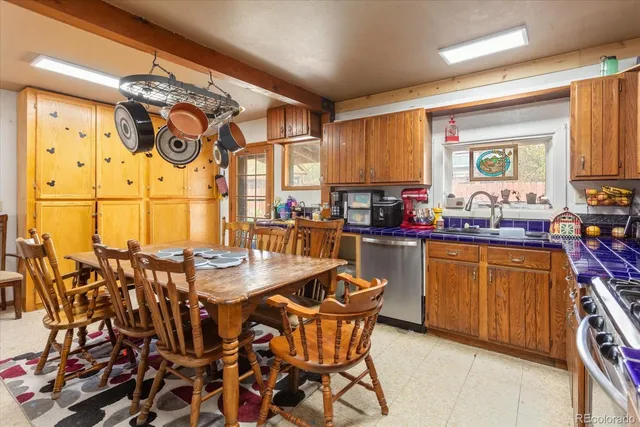 a kitchen with stainless steel appliances wooden cabinets and a stove top oven
