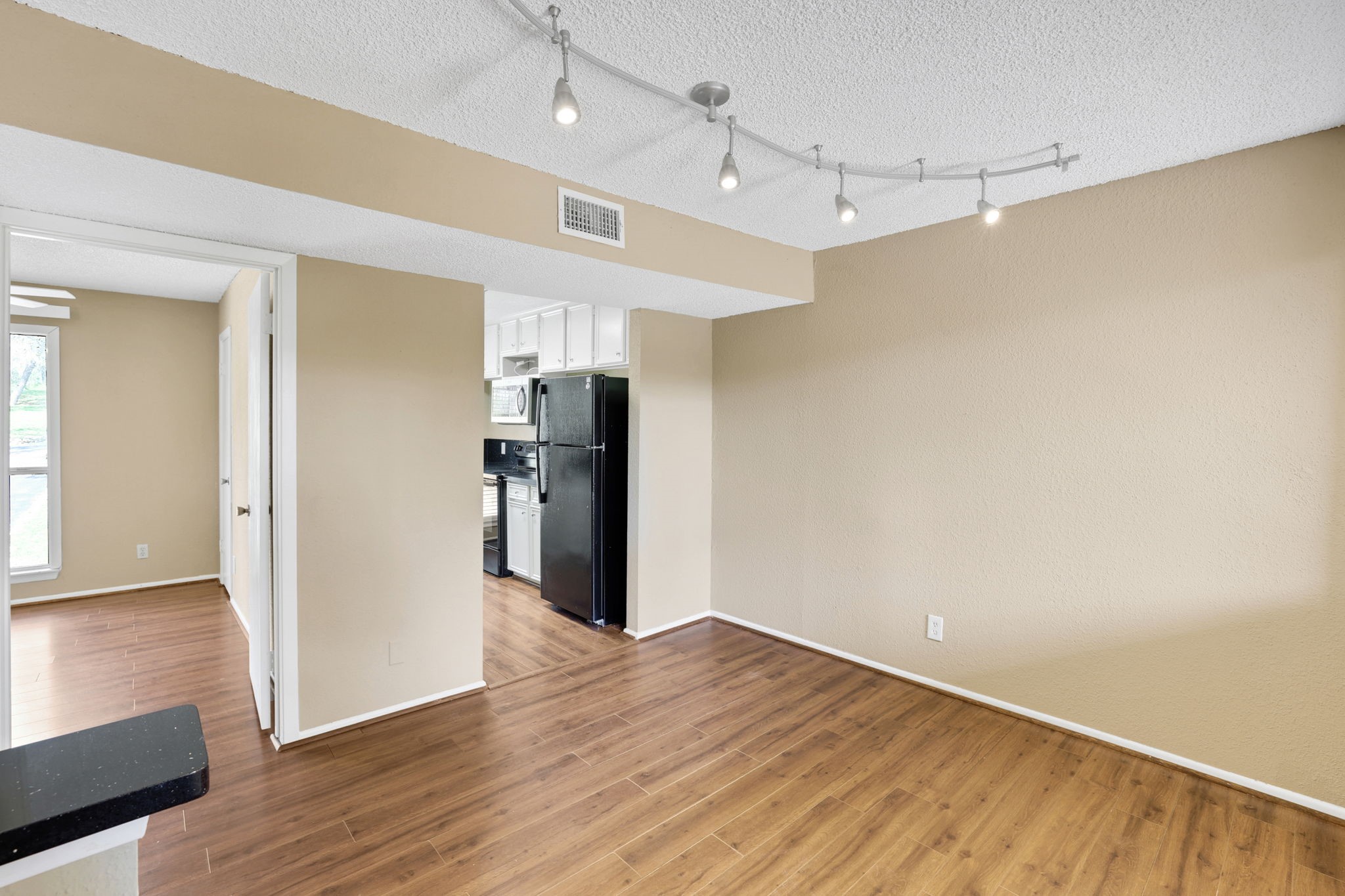 178 Villa Way Coldspring, TX 77331 - Photo 15 of 43 a view of a kitchen with a refrigerator and wooden floor