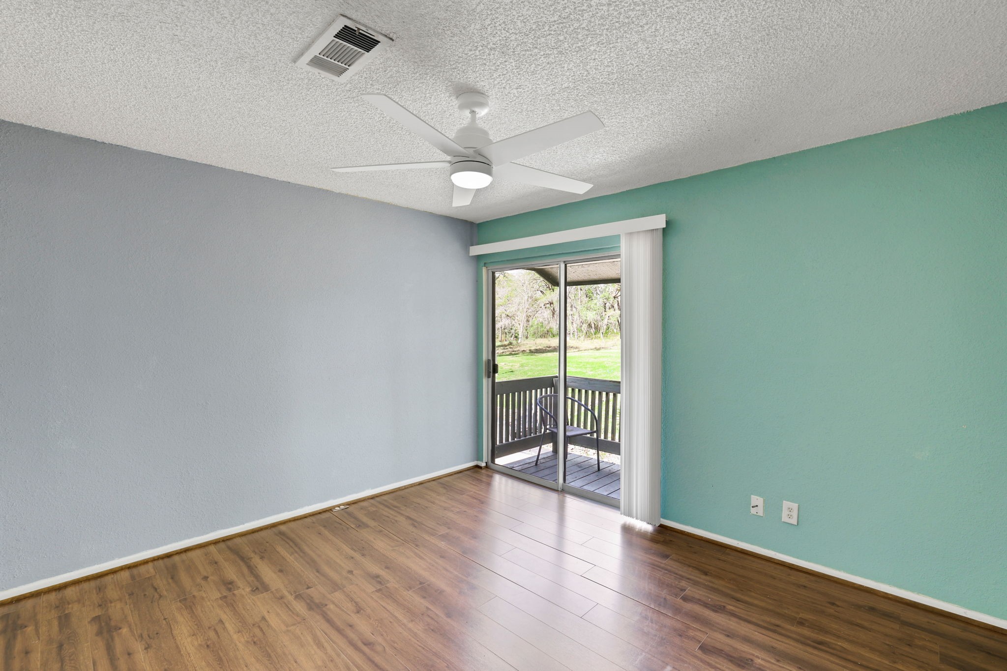 178 Villa Way Coldspring, TX 77331 - Photo 24 of 43 an empty room with wooden floor and fan