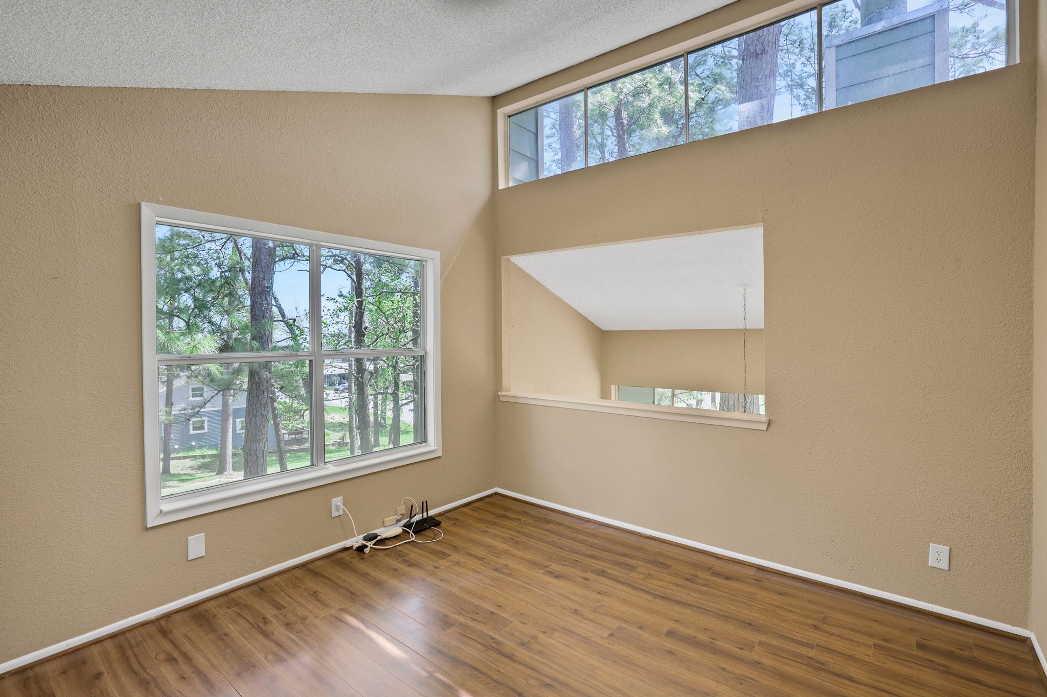 178 Villa Way Coldspring, TX 77331 - Photo 27 of 43 a view of an empty room with wooden floor and a window