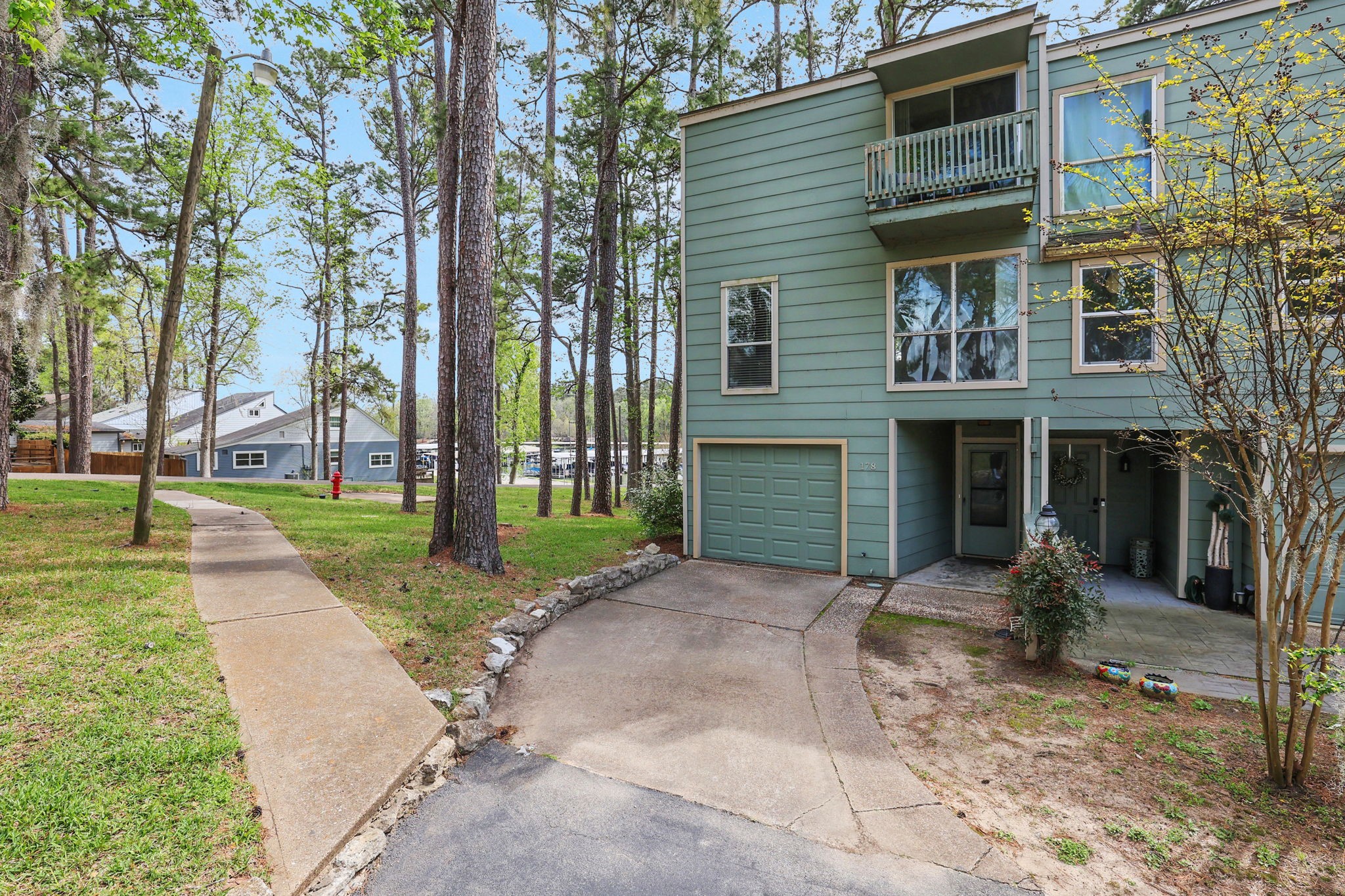 178 Villa Way Coldspring, TX 77331 - Photo 3 of 43 a front view of a house with garden and trees