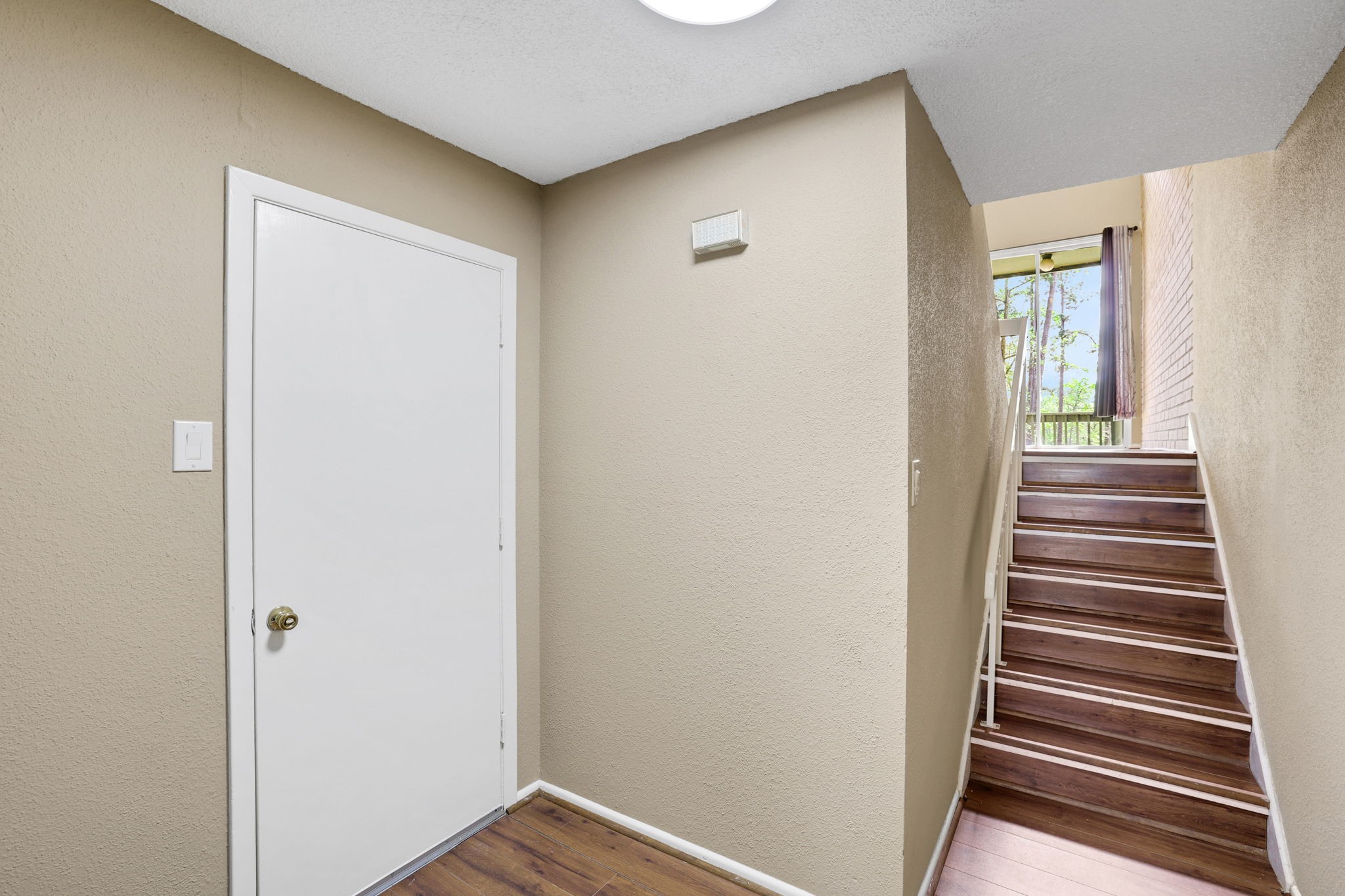 178 Villa Way Coldspring, TX 77331 - Photo 4 of 43 a view of a hallway with stairs and wooden floor