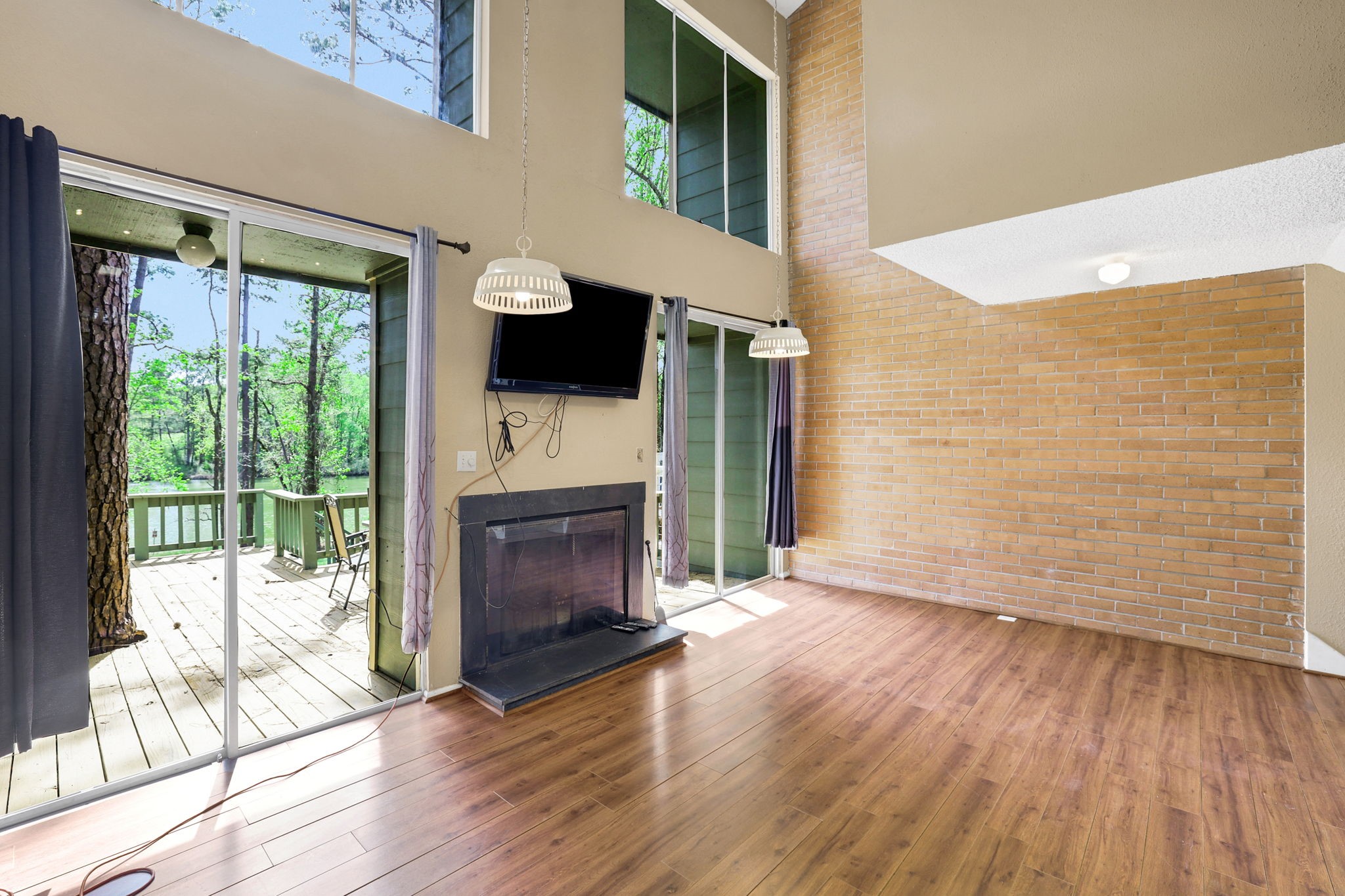 178 Villa Way Coldspring, TX 77331 - Photo 8 of 43 a view of an empty room with wooden floor and a window