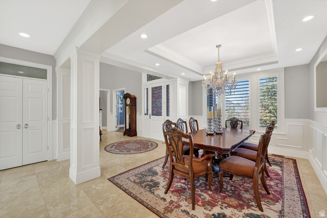 714 Draper Heights Way Draper, UT 84020 - Photo 15 of 88 Dining area with crown molding, a decorative wall, a wainscoted wall, suspended lighting, and a raised ceiling