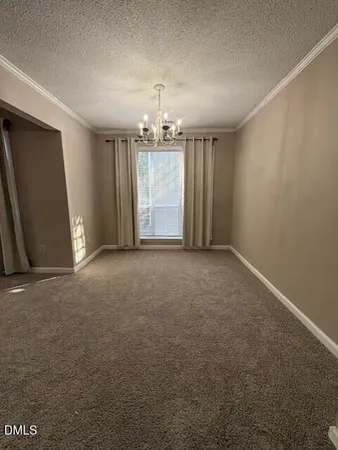 an empty room with windows and cabinet