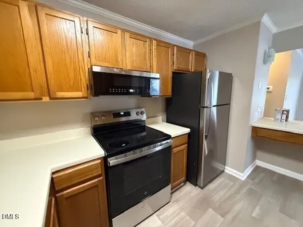 a kitchen with a refrigerator stove and microwave