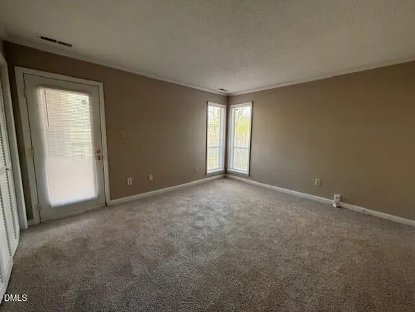 an empty room with windows and closet