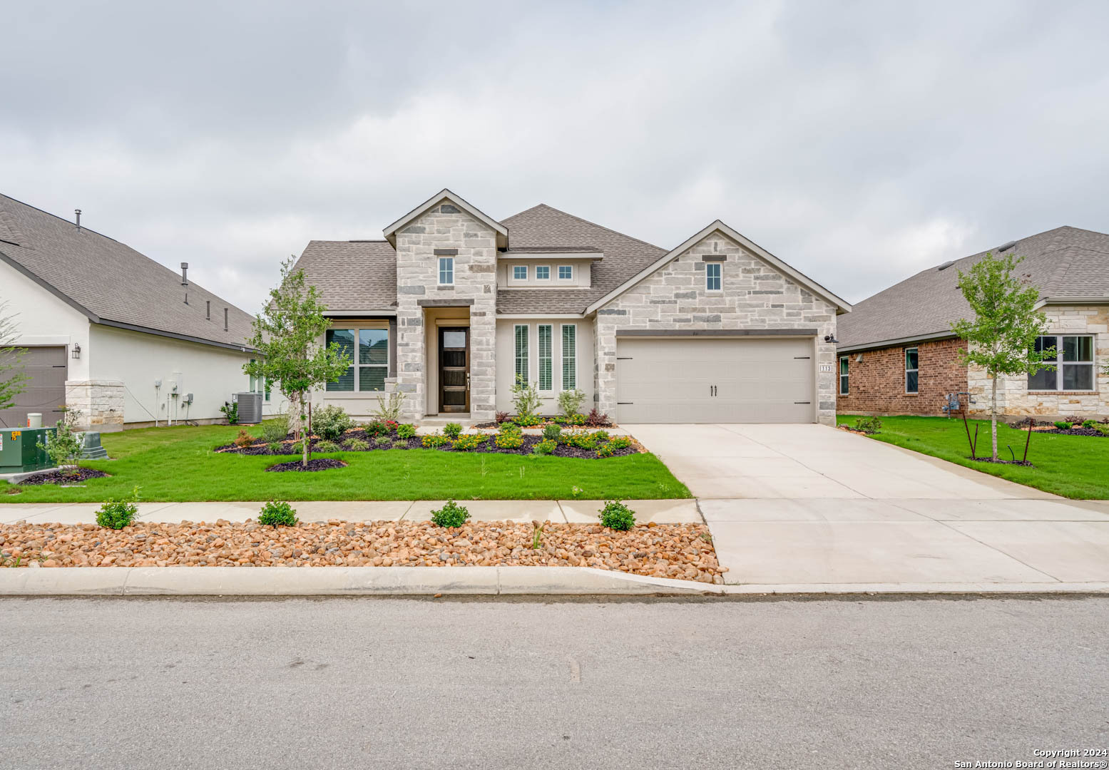 a front view of a house with a yard and garage