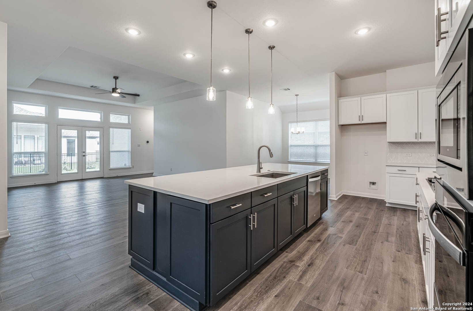 113 Valencia Boerne, TX 78006 - Photo 13 of 43 a kitchen with stainless steel appliances granite countertop a sink a stove and a wooden floors