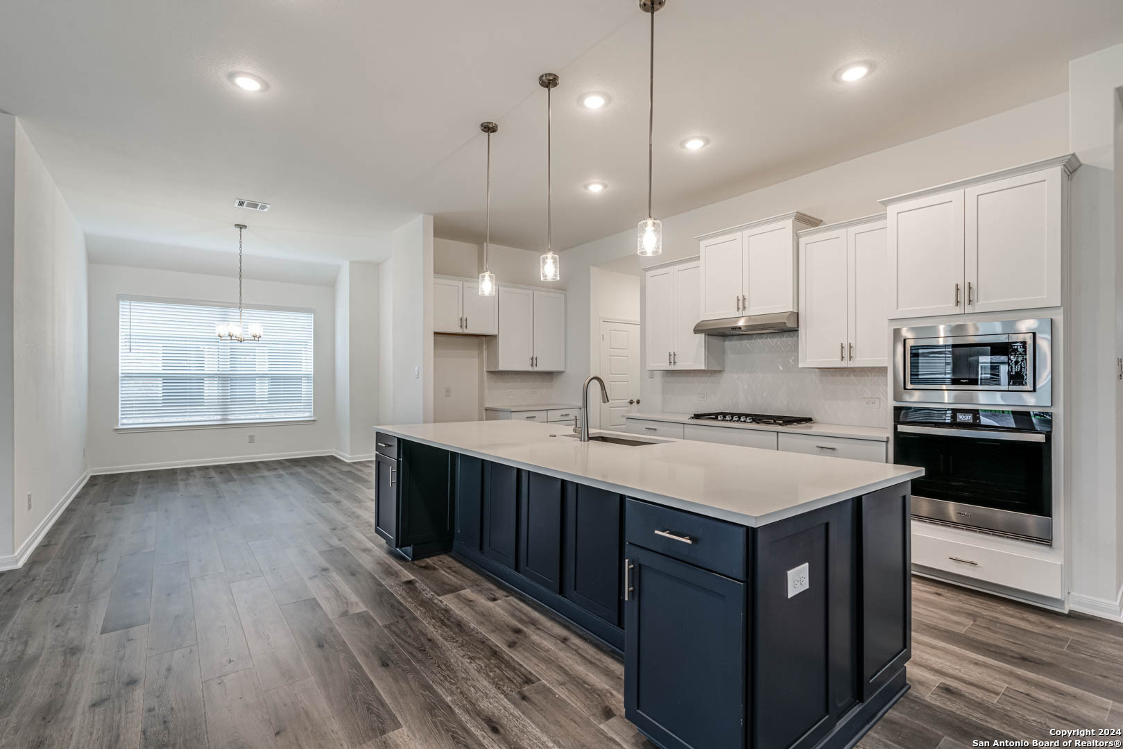 113 Valencia Boerne, TX 78006 - Photo 14 of 43 a kitchen with a sink a counter space appliances and cabinets