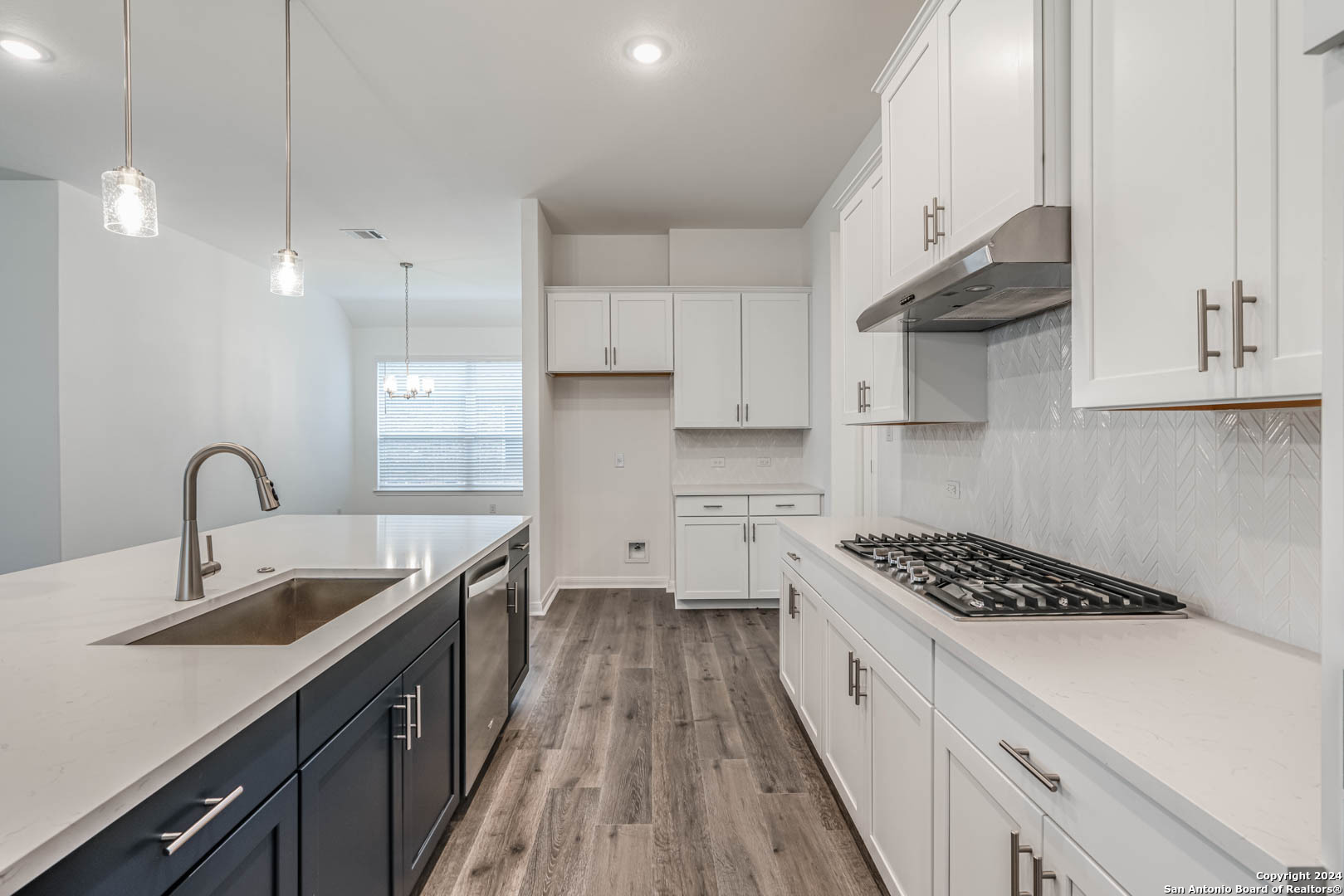 113 Valencia Boerne, TX 78006 - Photo 19 of 43 a kitchen with sink a stove and cabinets